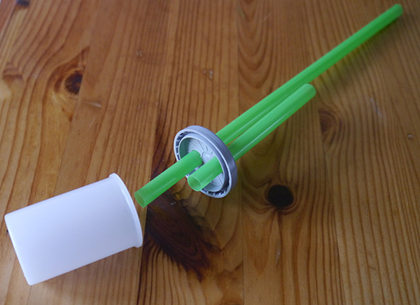 Straws placed through holes in film cannister lid
