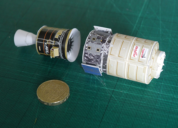 rocket models next to pound coin